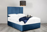 Blue upholstered bed with white bedding in a room setting.