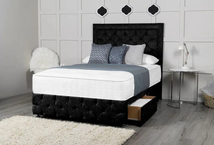 Bedroom with a black upholstered bed, white bedding, and decorative pillows.