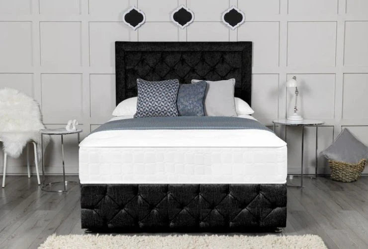 Bed with black tufted headboard and white bedding in a bedroom setting.