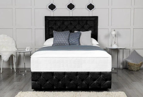 Bed with black tufted headboard and white bedding in a bedroom setting.