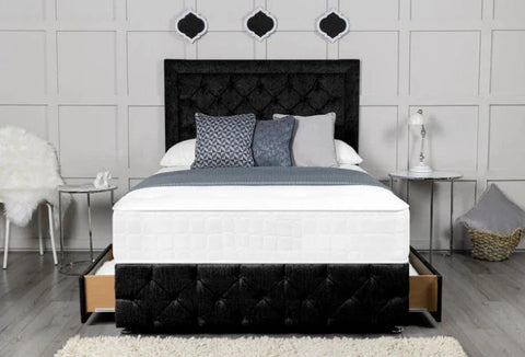 Bedroom with a black tufted bed frame and white bedding.
