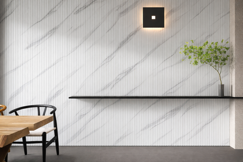 WPC slatted wall panel installed on a modern interior feature wall with vertical fluted texture.
