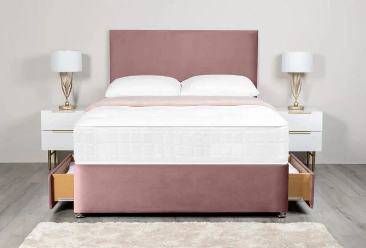Pink upholstered bed with white bedding and nightstands in a room setting.