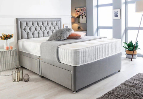 Gray upholstered bed in a modern bedroom setting with decor elements.