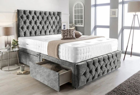 Gray tufted bed with storage drawers in a modern bedroom setting