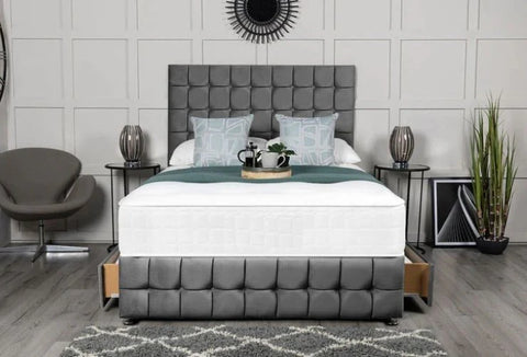 Bedroom with a gray upholstered bed, nightstands, and decor items.