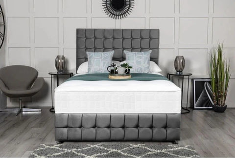 Gray upholstered bed in a modern bedroom setting with decor elements.