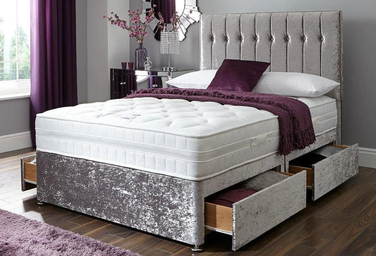 Bedroom with a bed featuring a tufted headboard and storage drawers, decorated with purple accents.