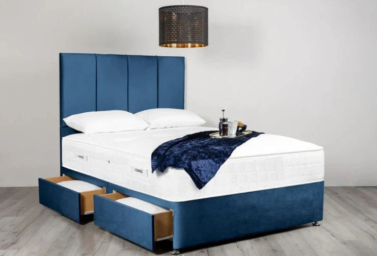 Blue upholstered bed with white mattress and storage drawers in a room setting.