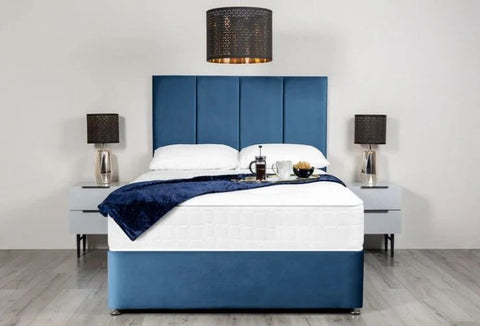 Blue and white bed with matching headboard in a bedroom setting.