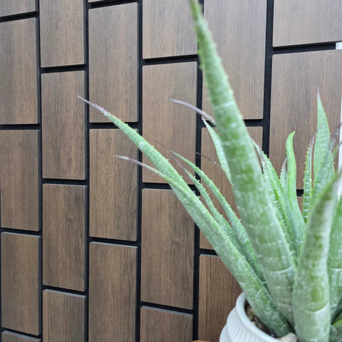 Brick-style acoustic wall panel with dark wood finish

