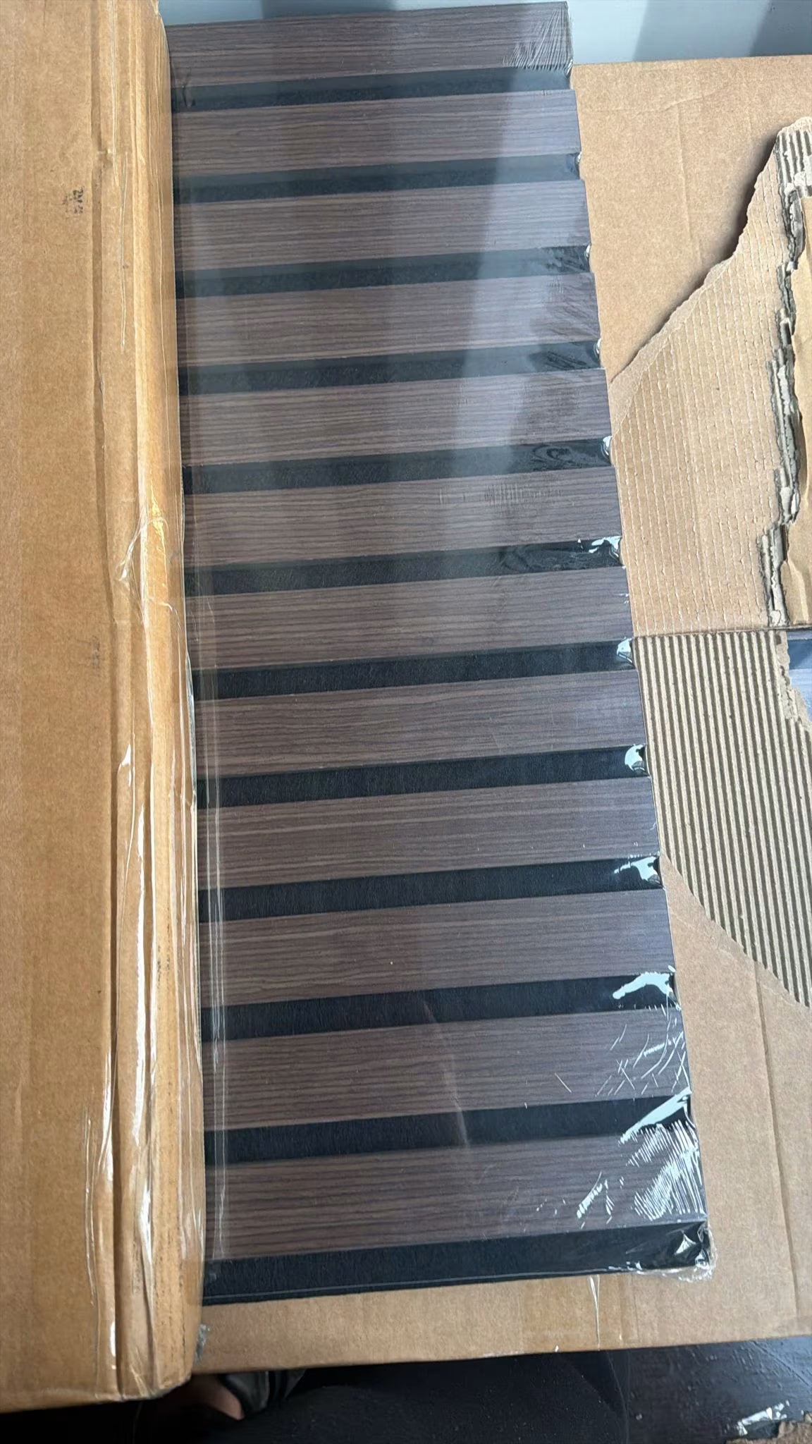 Acoustic slatted wall panel walnut timber effect room design

